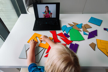 Poster - little girl play with puzzle, doing tangram, learning with online lesson