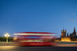 © robertharding - A red London bus goes past in a blur across Westminster Bridge, London, England