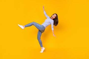 Full length body size view of her she nice attractive funky clumsy girlish comic childish girl jumping having fun fooling pretending fall isolated bright vivid shine vibrant yellow color background