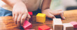 © N_studio - Closeup hand of boy playing wooden block toy on table for creative with enjoy, happy child learn skill for activity puzzle and creativity for game on desk at home, education concept, banner website.