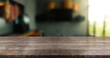 Fototapeta  - Wooden top table with bokeh light effect and blur restaurant on background, blur background