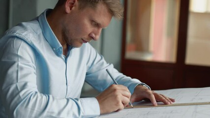 Poster - Young architect with construction plan in office