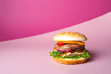 Fresh juicy beef hamburger placed on creative pink background. Copy space for text, trendy hero view, horizontal