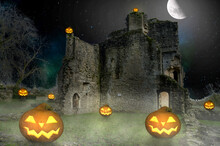 Scary Halloween Pumpkin Lanterns In Front Of An Old Castle At Night