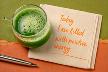 today I am filled with a positive energy - inspirational note on a napkin with a glass of fresh green cucumber juice, lifestyle and positivity concept