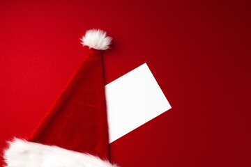 Santa Claus hat on red background top view