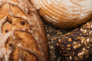 Wall Mural - close up view of fresh baked bread loaves on wooden surface