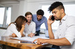 © NDABCREATIVITY - Group of business people meeting in office, sharing their ideas.