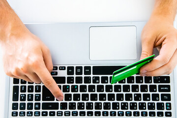 Canvas Print - Top view of a person using his credit card and laptop - concept of online shopping