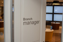 Close Up Shot Of Branch Manager On Partially Open Door