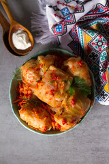 Wall Mural - Cabbage rolls with meat, rice and vegetables. Chou farci, dolma, sarma, golubtsi or golabki. View from above, top studio shot