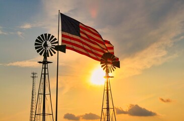windmill and american flag at sunset