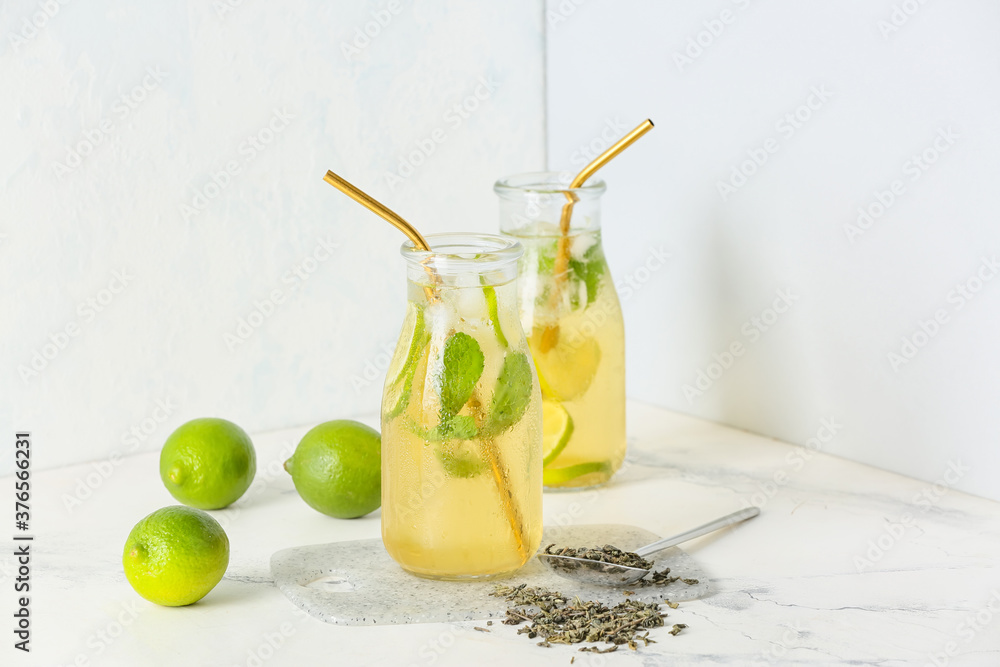 Bottles of tasty cold ice tea on white background