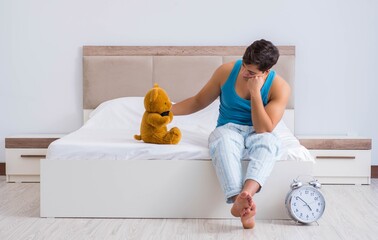 Wall Mural - Young man waking up in bed