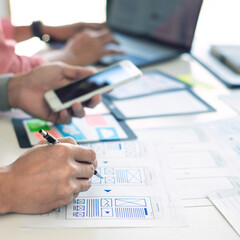 Team User experience (UX) designer creative graphic planning or designing application development a prototype for mobile phone or smartphone layout.
