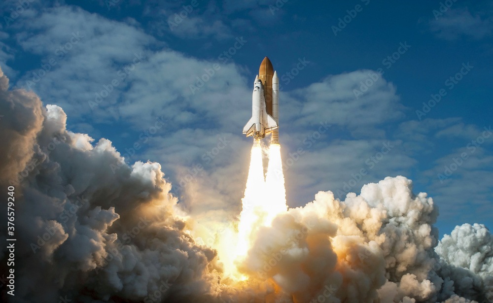 Spaceship takes off into the night sky on a mission. Rocket starts into space concept.Elements of this image furnished by NASA - obrazy, fototapety, plakaty 