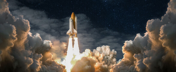 Wall Mural - spaceship takes off into the night sky on a mission. rocket starts into space concept.elements of th