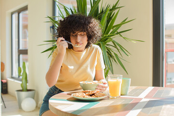 Wall Mural - young and pretty arab woman having a breakfast at home.