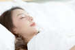 © sopradit - Asian women sleeping and sweet dream on white bed in bedroom
