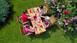 © Iuliia Sokolovska - Family and friends eating together outdoors on summer garden party. Aerial view of table with food and drinks from above. Leisure, holidays and picnic concept