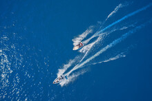 Top View Of Two Boats Sailing At High Speed. Aerial View Of Boats In Motion On Blue Water.