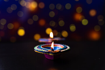 Wall Mural - Indian festival Diwali, Diya oil lamps lit on colorful rangoli. Hindu traditional. Happy Deepavali. Copy space for text.