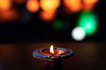 Wall Mural - Indian festival Diwali, Diya oil lamps lit on colorful rangoli. Hindu traditional. Happy Deepavali. Copy space for text.