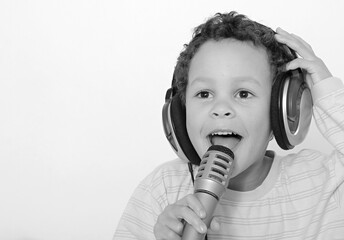 Wall Mural - child with headphones enjoying music   on white background stock photo  