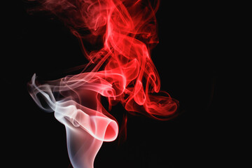 Red smoke on a black background. Colored smoke. Incense stick smoke, illuminated by red light.