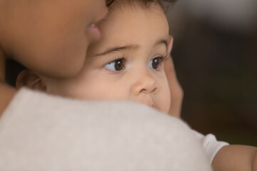 Wall Mural - close up head shot affectionate african american woman cuddling sweet funny little biracial baby boy