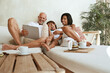 © puhhha - Family Fun At Home. Dad, Mom And Little Boy Sitting On Sofa In Living Room With Tablet. Parents Drinking Tea, Using Portable Digital Device And Enjoying Leisure On Weekend.