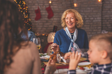 Mother and daughter speaking over Christmas dinner