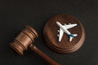 Wooden Judges gavel and toy plane. Aviation Law. To sue the airline.
