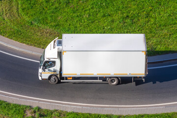 Wall Mural - Small white truck on the highway turn.