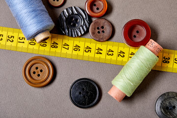 Fototapete - Background and texture of multicolored antique buttons and sewing tools