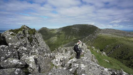 Canvas Print - A man climbing down rocks in the Welsh mountains