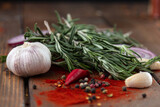 Fototapeta Kuchnia - spices onion red pepper garlic on wood board