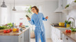 © Gorodenkoff - Happy Young Man with Long Hair is Using Smartphone in a Kitchen while Wearing Blue Pajamas. He is Scrolling Social Meadia and News Feed. Energetic Man Having a Healthy Breakfast.
