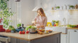 © Gorodenkoff - Young Female in Striped Jumper is Making a Healthy Organic Salad in a Modern Sunny Kitchen. Authentic Woman is Chopping a Cauliflower with a Knife. Natural Clean Diet and Healthy Way of Life Concept.