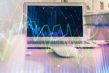 Financial market graph hologram and personal computer on background. Double exposure. Concept of forex.