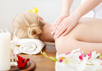 Wall Mural - Female hands do massage on girl shoulders, lying on table