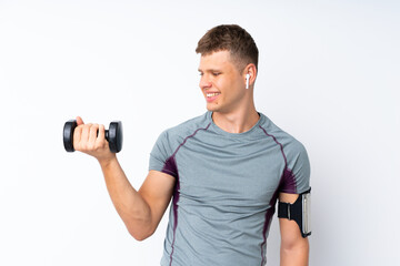 Wall Mural - Young sport man with weightlifting over isolated white wall with happy expression