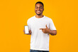 © Prostock-studio - Positive Black Guy Showing Phone Empty Screen On Yellow Background