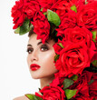 © Svetlana Fedoseeva - Beautiful woman face surrounded by red roses. Perfect skin. Professional makeup.