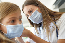 Kid At Doctor's Office With Protection Face Mask Having Temperature Checked