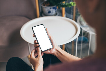 cell phone mockup blank white screen.woman hand holding texting using mobile on desk at coffee shop.background empty space for advertise.work people contact marketing business,technology