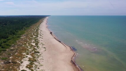 Wall Mural - Aerial view flying along Latvian Baltic sea seaside beach coast. People on beach