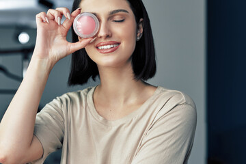 Canvas Print - Professional makeup artist girl smiling and posing with her favorite beauty product. Beauty blogger woman making herself make-up while recording her video for her blog on cosmetics.