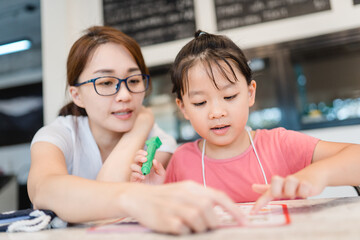 Covid-19 Coronavirus and Online learning from home, Home school kid.Little asian girl study with online learning class with mother work from home with tablet.Stay home,New normal, Social distancing.