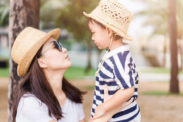 Wall Mural - Happy loving family.Asian mother and baby boy child talking in playground outdoor at the park.Cute child with mother encourage and play.Child development,Mother and son traveller, Healthcare, People.